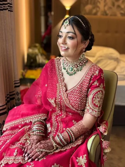 A candid moment of the bride looking away, captured in beautiful light. The makeup is soft and blended, ensuring there are no harsh lines and that she looks elegant from every angle.