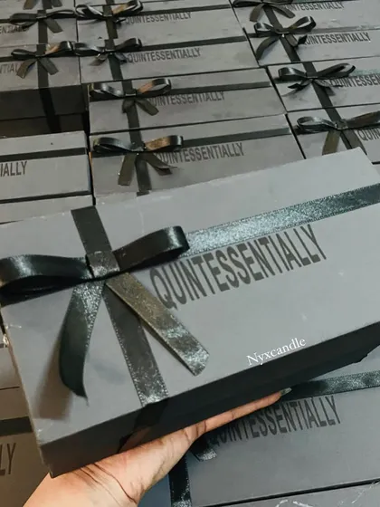 A full view of the finished corporate gift boxes for "Quintessentially," all tied with a black ribbon. This shows our attention to detail and our ability to deliver a large volume of professionally packaged gifts.