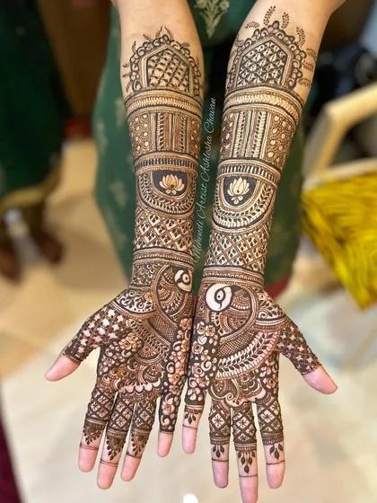 A full-arm mehendi design with lotus and peacock motifs. The intricate patterns and symbolic elements create a beautiful and traditional look.