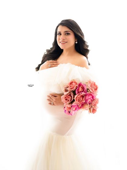A simple, high-key portrait with a beautiful bouquet of pink and peach roses. Sometimes, a simple prop is all you need.
