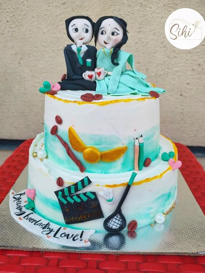 This cake tells the story of a couple who found love over coffee. It features custom fondant figurines of the couple, along with edible details representing their shared interests like movies, badminton, and Harry Potter.