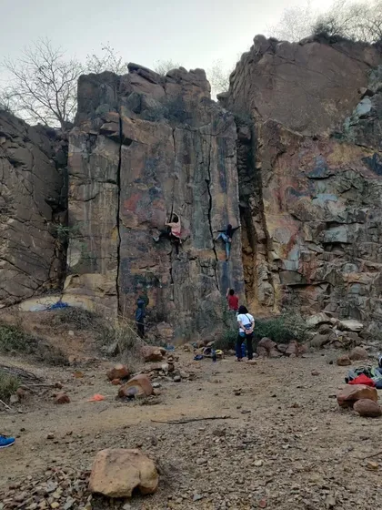 Climbers spread out across the crag at Dhauj. Roped climbing allows multiple people to climb different routes at the same time, making for a dynamic day outdoors.