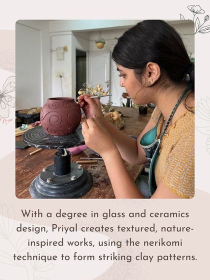 A photo of Priyal, who has a degree in glass and ceramics design, carving one of her textured, nature-inspired pieces.