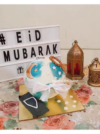 A special piñata cake I made for an Eid celebration. The chocolate sphere is decorated with a crescent moon and stars and comes with a small hammer to break it open and reveal the treats inside.