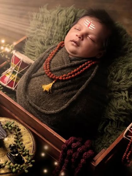 Another beautiful interpretation of the little Mahadev theme, with glowing lights adding a divine aura to the portrait. We take great care in arranging every detail of our cultural photoshoots.