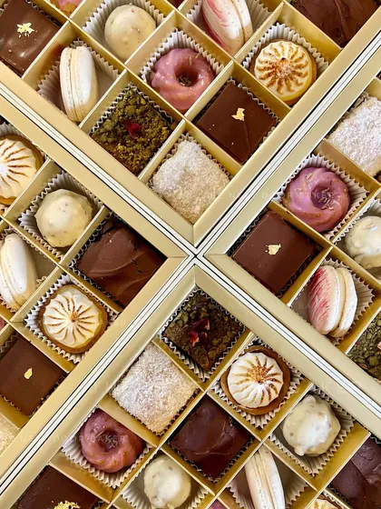 A close-up of my Diwali dessert boxes, where every piece is crafted to represent an emotion of the festival. You can see the variety of textures and flavors, from creamy cheesecakes and delicate macarons to rich fudges, all arranged like jewels.