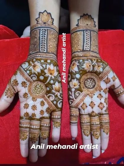 A gorgeous mehandi design centered around the lotus motif. The palms feature large, blooming lotuses, which are also used as a repeating pattern on the wristbands.