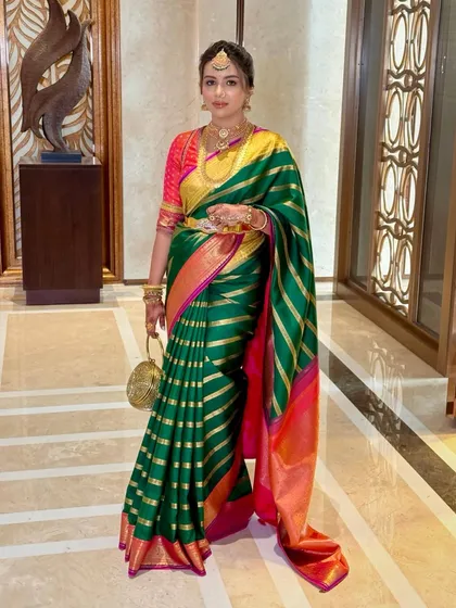 An elegant pose capturing the beautiful drape of the saree and the client's confident presence.