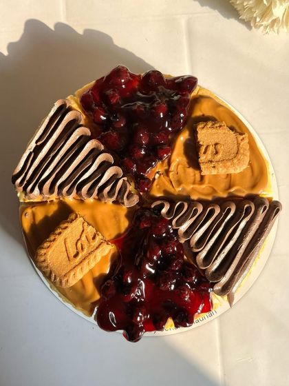 Isn't this tempting? A beautiful shot of my assorted cheesecake, showcasing the rich colors of the blueberry compote, the smooth Lotus Biscoff spread, and the decadent chocolate.