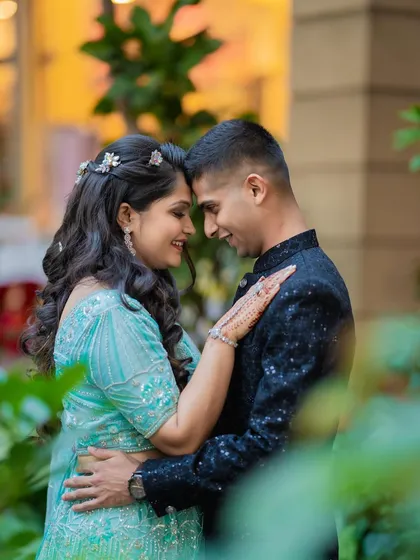 An intimate and romantic portrait of Lieutenant Army Officers Diksha and Vighnesh. This close-up shot, framed by greenery, focuses on their quiet connection.