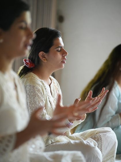 A close-up of a student chanting during a workshop. Each person's journey is unique, yet we support each other through our shared practice.
