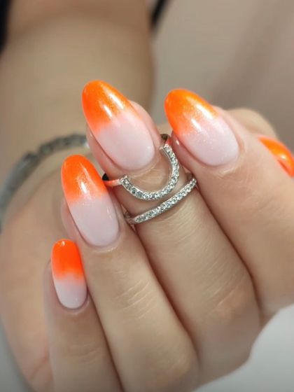 A bright and fiery ombré, fading from a sheer nude to a bold neon orange. This look is perfect for making a statement.