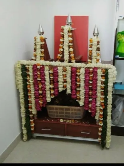 We provide decoration services for even the smallest home temples (mandirs). Here, we created a small structure around the temple using garlands of fresh white, pink, and red flowers.
