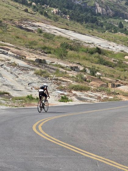 A solo rider tackling a winding, hilly road during the Rajyotsava 200k. The route included a mix of highways and scenic backroads, offering a great cycling experience.
