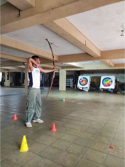 This student is in the middle of his shooting sequence, showing the focus required to hit the bullseye.