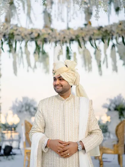 The groom, Aditya, waiting for his bride with a happy and expectant smile. A perfect portrait of a groom in love.