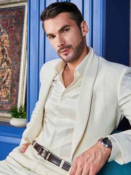 Confidence personified. This shot captures the essence of wearing a custom-made ivory tuxedo, combining luxurious fabric with a fit that is built around you.