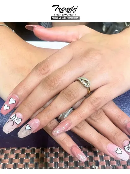 Here is another look at the adorable hearts and bows design. The combination of glitter, soft pink, and hand-painted details makes this a popular choice for a fun and feminine manicure.