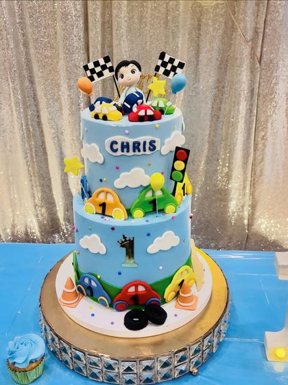 The car-themed cake on its beautiful crystal stand, ready for the celebration.