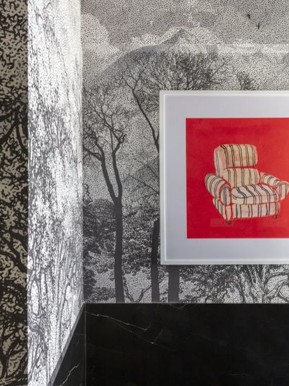 The powder bathroom is a space to make a statement. Here, I used a custom landscape wallpaper, dark marble, and a quirky piece of art to ensure this small room becomes a memorable conversation starter.