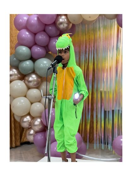 Even in a dinosaur costume, this young performer delivers his monologue with focus and character, showing that confidence comes in all forms.
