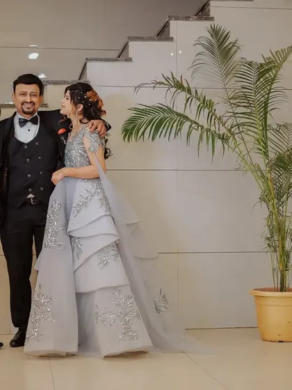 A candid moment of the couple sharing a laugh with a family member. These interactions are a precious part of any wedding event.