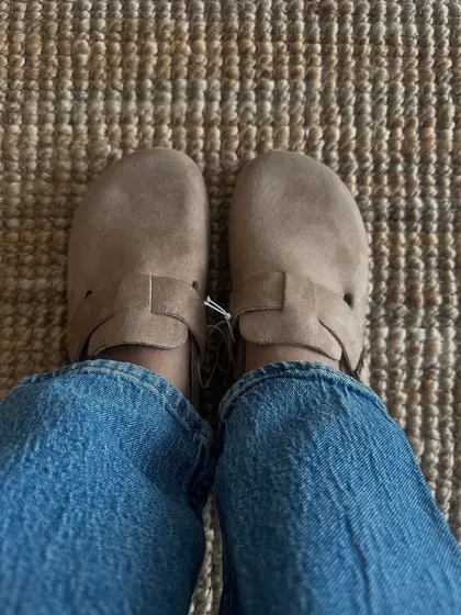 A customer trying on the same clog style, this time in a lighter taupe colour. It's a great neutral that goes with everything.