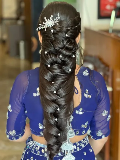 The mermaid braid is a style I absolutely love creating. This look features a thick, multi-layered braid, detailed with small pearls throughout for a touch of elegance, and finished with a sparkling hair accessory.