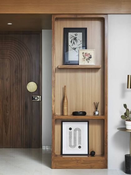 In the 'Tranquil Tides' project, I designed a floor-to-ceiling wooden panel to discreetly house the family's mandir. This solution provides a sacred space while maintaining the living room's clean aesthetic.