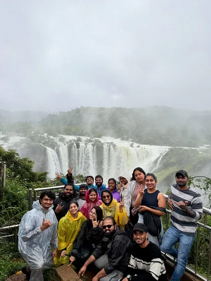The whole group celebrating their visit to the magnificent Jog Falls during peak monsoon season.