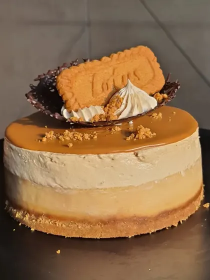 Another angle of the individual Biscoff cheesecake, showing the distinct layers of biscuit base and creamy filling.