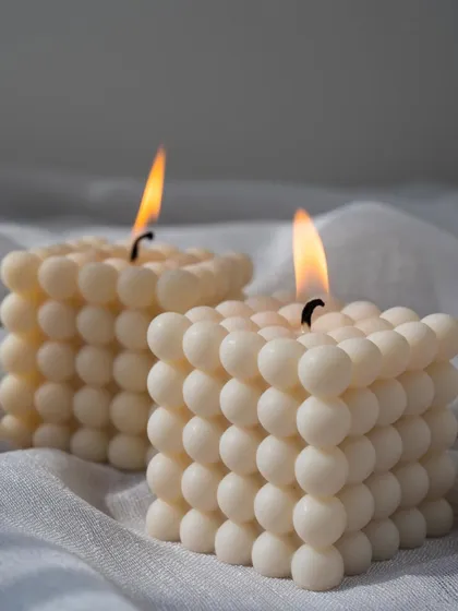 Two of our large bubble candles lit, creating a warm and cozy atmosphere. Their unique texture and shape make them a customer favorite.