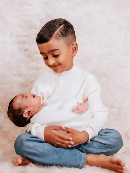The sweet, gentle bond between siblings is one of my favorite things to photograph. This quiet moment between a big brother and his new baby sibling is simply precious.