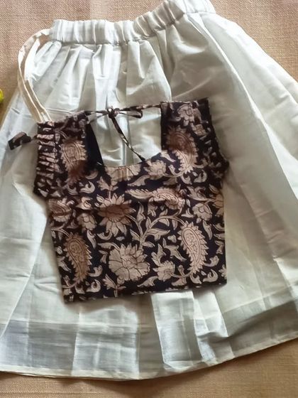 Part of my limited Vishu collection, this set features a tissue silver border paavada with a black Kalamkari top. I always add pockets to my paavadas for little ones to keep their treasures.