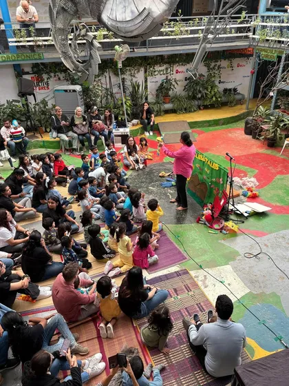 I can turn any space, big or small, into a theatre of imagination. Here I am at a school event, sharing a story with over a hundred families. It brings me so much joy to see both kids and parents completely absorbed in the performance together.