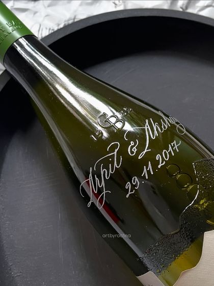 A personalized wine bottle, engraved with names and a wedding date. I've lost count of how many bottles I've customized, but with each one, I try to refine my skill and make it better than the last.