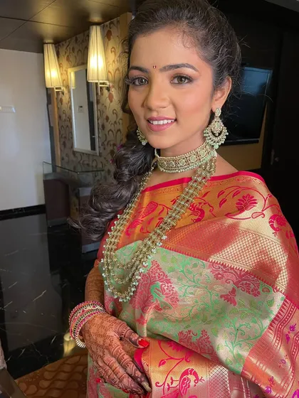 The complete engagement look, with a stunning pastel saree and traditional jewelry.