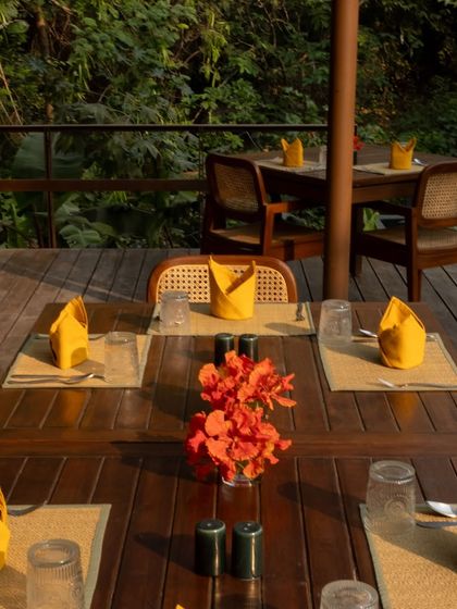 A table set for a winter brunch on the deck, with vibrant orange flowers adding a pop of color.