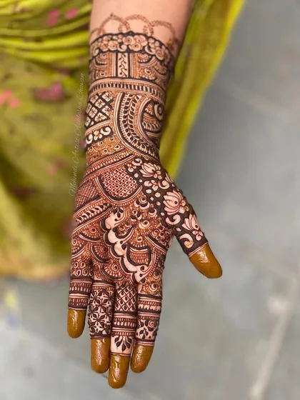 A single hand from a full-coverage design. This close-up shows the detail and precision in the line work and filling.
