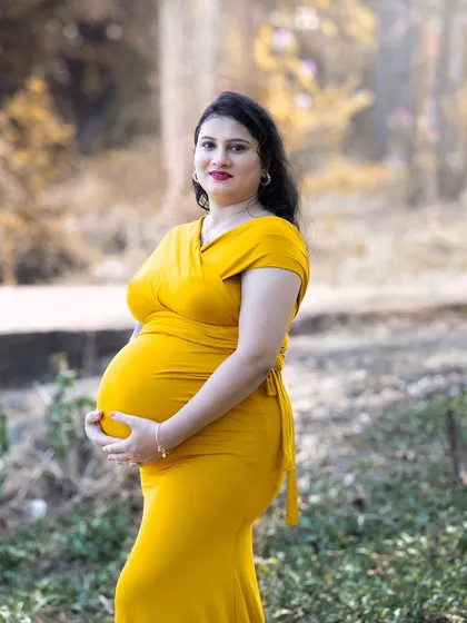 My photography style often uses the warm, golden glow of natural light to create soft and intimate portraits. This medium shot focuses on the mother's happy expression, capturing a quiet moment of connection in a beautiful, naturally lit setting.