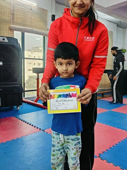 A young boy proudly holds his "Awesomeness" certificate.