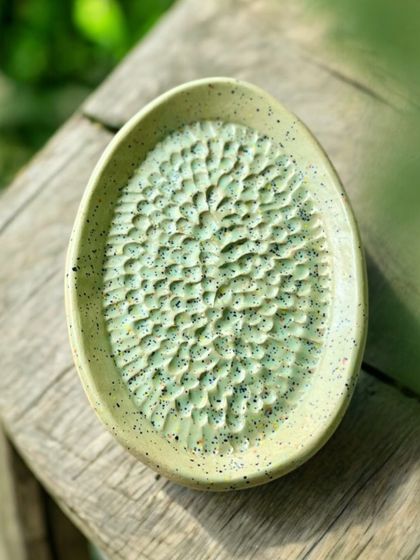 This small, oval dish has a deeply textured surface that catches the light and the glaze in interesting ways. It's a great example of how I use texture to add character to my functional pottery.