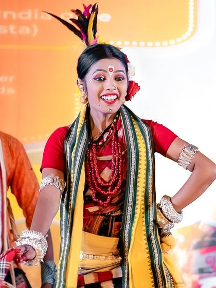 The vibrant joy of a folk dancer performing at Kartavya Path. Her colorful costume and expressive face make for a captivating cultural photograph.