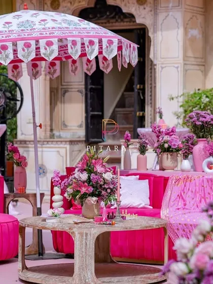 We added these beautiful printed parasols to provide shade and style. The combination of the modern fuchsia furniture and the traditional Indian parasol creates a unique fusion look.