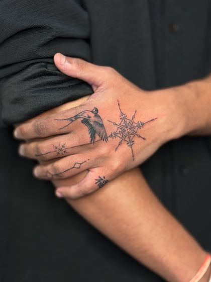 A stylish shot of the client's hand tattoo, with his hand resting on his arm.