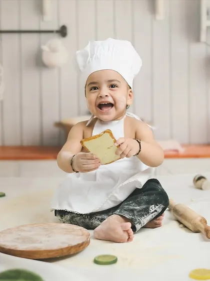 Capturing pure joy during a 'Little Chef' themed first birthday shoot. I love creating playful and unique sets like this miniature kitchen, where little ones can make a happy mess and show off their personality.
