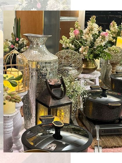 An elegant buffet setup with candles, flowers, and mirrored vases, creating a sophisticated and glamorous atmosphere for an evening event.