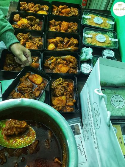 The packing process for a country chicken gravy order. I weigh each portion to ensure consistency.