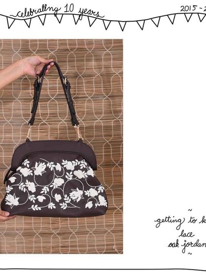 The front view of the Lace Oak Jordan, showcasing the beautiful and intricate white floral embroidery.