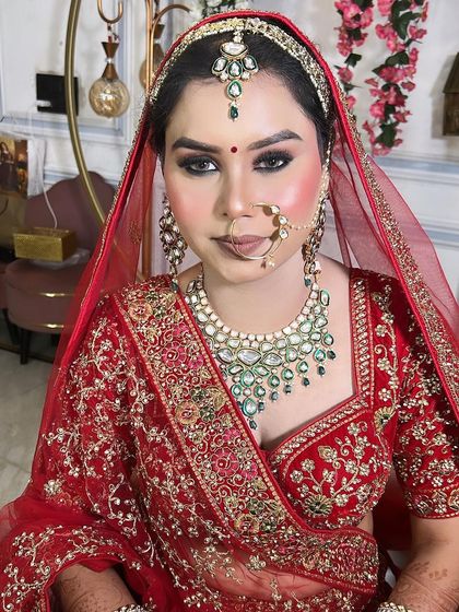 Another angle of this stunning bridal look. The red dupatta frames her face beautifully, highlighting the flawless skin and bold eye makeup.